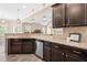 Kitchen featuring granite countertops, dark cabinets, stainless steel appliances at 347 Country Mill Way, Fuquay Varina, NC 27526