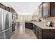 Gourmet kitchen with stainless appliances, dark wood cabinets and granite countertops at 347 Country Mill Way, Fuquay Varina, NC 27526
