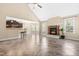 Open living space with vaulted ceiling, stone fireplace, kitchen, and breakfast bar at 347 Country Mill Way, Fuquay Varina, NC 27526