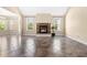 Cozy living room featuring a stone fireplace, large windows, and bright lighting at 347 Country Mill Way, Fuquay Varina, NC 27526