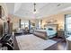Airy primary bedroom suite with hardwood flooring, tray ceilings, and comfortable sitting area at 347 Country Mill Way, Fuquay Varina, NC 27526