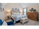 Well decorated main bedroom featuring a wrought iron bed frame and sitting area at 347 Country Mill Way, Fuquay Varina, NC 27526