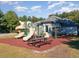 Community playground with slides, climbing structures, and a picnic table for Gathering fun and recreation at 347 Country Mill Way, Fuquay Varina, NC 27526