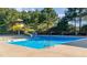 Community pool featuring a yellow water slide and well-maintained deck, perfect for summer fun at 347 Country Mill Way, Fuquay Varina, NC 27526