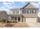 Two-story brick home with a landscaped front yard and attached garage at 370 Hickory Run Ln, Franklinton, NC 27525