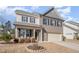Two-story home with gray and brown brick exterior, landscaping, and a two-car garage at 370 Hickory Run Ln, Franklinton, NC 27525