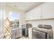Laundry room with washer, dryer, and ample cabinet space at 370 Hickory Run Ln, Franklinton, NC 27525