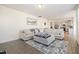 Open living room with a sectional sofa, ottoman, and view into the kitchen area at 370 Hickory Run Ln, Franklinton, NC 27525