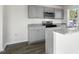 Gray cabinets, granite countertops, and stainless steel appliances in the kitchen at 408 Honeycutt Oaks Dr, Angier, NC 27501