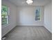Bright bedroom with carpet flooring and large windows at 4532 Hidden Hollow Ln, Knightdale, NC 27545