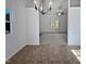 Bright dining room with chandelier and view into living room at 4532 Hidden Hollow Ln, Knightdale, NC 27545