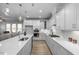 Modern kitchen with white cabinets, quartz countertops, and stainless steel appliances at 4809 Bristol Meadow Dr, Raleigh, NC 27603