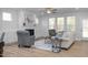 Bright living room with fireplace, hardwood floors, and access to back porch at 4809 Bristol Meadow Dr, Raleigh, NC 27603