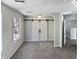 Bedroom with barn door, carpet, and window at 5340 Fayetteville Rd, Durham, NC 27713