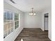Simple dining area with new flooring and large windows at 5340 Fayetteville Rd, Durham, NC 27713