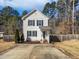Two-story house with a light-colored exterior, driveway, and landscaped yard at 5340 Fayetteville Rd, Durham, NC 27713