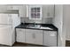 Kitchen with white cabinets, double sink and dishwasher at 5340 Fayetteville Rd, Durham, NC 27713