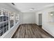 Bright living room with large windows and wood-look flooring at 5340 Fayetteville Rd, Durham, NC 27713