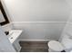 Clean powder room with pedestal sink and wainscoting at 5340 Fayetteville Rd, Durham, NC 27713