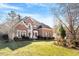 Two-story brick house with a large green lawn and mature trees at 5612 Crossfield Dr, Raleigh, NC 27613