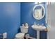 Powder room with pedestal sink and blue walls at 5612 Crossfield Dr, Raleigh, NC 27613