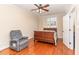 Guest bedroom with hardwood floors, a double bed, and a recliner at 58 Alecia Ct, Clayton, NC 27527