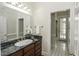 Bathroom with dark marble vanity and access to hallway at 5891 Baker Ln, Rocky Mount, NC 27803