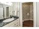 Powder room with marble vanity and floral wallpaper at 5891 Baker Ln, Rocky Mount, NC 27803
