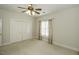 Well-lit bedroom with double doors and ceiling fan at 5891 Baker Ln, Rocky Mount, NC 27803