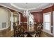 Elegant dining room featuring a large wood table, chandelier, and hardwood floors at 5891 Baker Ln, Rocky Mount, NC 27803