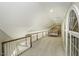 Upstairs hallway with carpet, railing, and bedroom view at 5891 Baker Ln, Rocky Mount, NC 27803