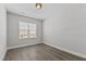 Bedroom with hardwood floors and a bright window, creating a cozy atmosphere at 608 Marshskip Way, Rolesville, NC 27587