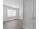 Bedroom featuring a large window, hardwood floors, and a double-door closet at 608 Marshskip Way, Rolesville, NC 27587