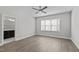 Bedroom showcasing an ensuite bathroom, hardwood floors, and a modern ceiling fan at 608 Marshskip Way, Rolesville, NC 27587
