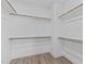 Walk-in closet with built-in shelving and hardwood floors, offering ample storage at 608 Marshskip Way, Rolesville, NC 27587