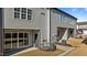 Exterior of gray townhouses featuring individual patios and gray doors at 608 Marshskip Way, Rolesville, NC 27587