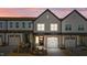 Charming townhome showcasing a well-manicured lawn, attached garage, and craftsman-style details at 608 Marshskip Way, Rolesville, NC 27587