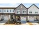 Charming townhome showcasing a well-manicured lawn, attached garage, and craftsman-style details at 608 Marshskip Way, Rolesville, NC 27587