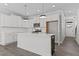 Bright and airy white kitchen featuring an island, pendant lighting and stainless steel appliances at 608 Marshskip Way, Rolesville, NC 27587
