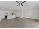 Open-concept living space with hardwood floors and a view of the modern kitchen at 608 Marshskip Way, Rolesville, NC 27587