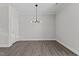 Dining area with light fixture and hard surface floors next to a door at 608 Marshskip Way, Rolesville, NC 27587