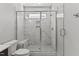 Walk-in shower with marble surround, glass enclosure, and a built-in bench at 608 Marshskip Way, Rolesville, NC 27587