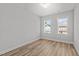 Bright bedroom featuring natural light from two windows, and sleek wood-look flooring at 610 Marshskip Way, Rolesville, NC 27587