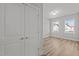 View of bedroom featuring a window and sleek wood-look flooring, accessible through the doorway at 610 Marshskip Way, Rolesville, NC 27587