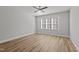 Bright bedroom featuring modern ceiling fan, wood-look flooring, and natural light from a window at 610 Marshskip Way, Rolesville, NC 27587