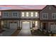 Charming townhome featuring attached garage, craftsman details, and manicured front yard at 610 Marshskip Way, Rolesville, NC 27587
