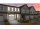 Modern townhome exterior with a two-car garage and clean lines, showcasing contemporary design and curb appeal at 610 Marshskip Way, Rolesville, NC 27587