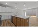Spacious kitchen featuring modern stainless steel appliances and an island with a sink at 610 Marshskip Way, Rolesville, NC 27587