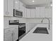 Modern kitchen with stainless steel appliances, quartz countertops, and island sink at 610 Marshskip Way, Rolesville, NC 27587