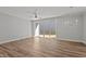 Open living room with modern lighting fixture and sliding glass doors at 610 Marshskip Way, Rolesville, NC 27587